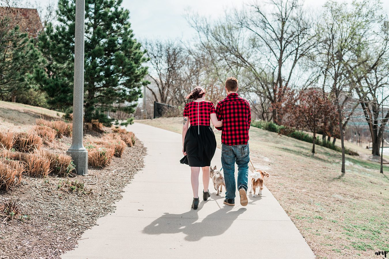 Ben and Courtnee walking their dogs along the riverfront