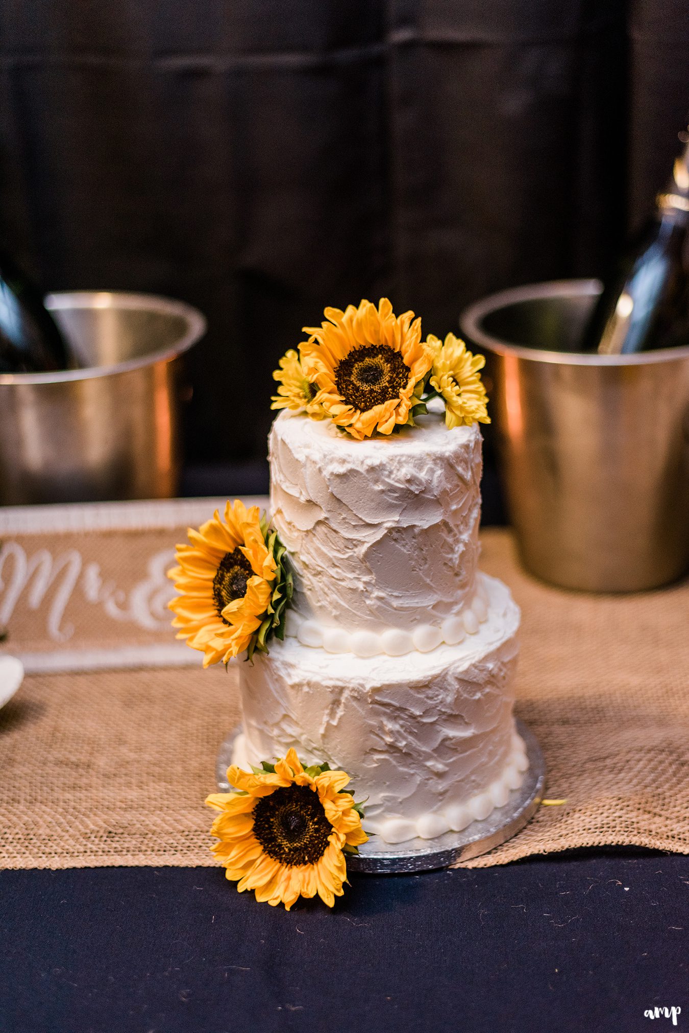 White frosted cake with sunflowers adorning it