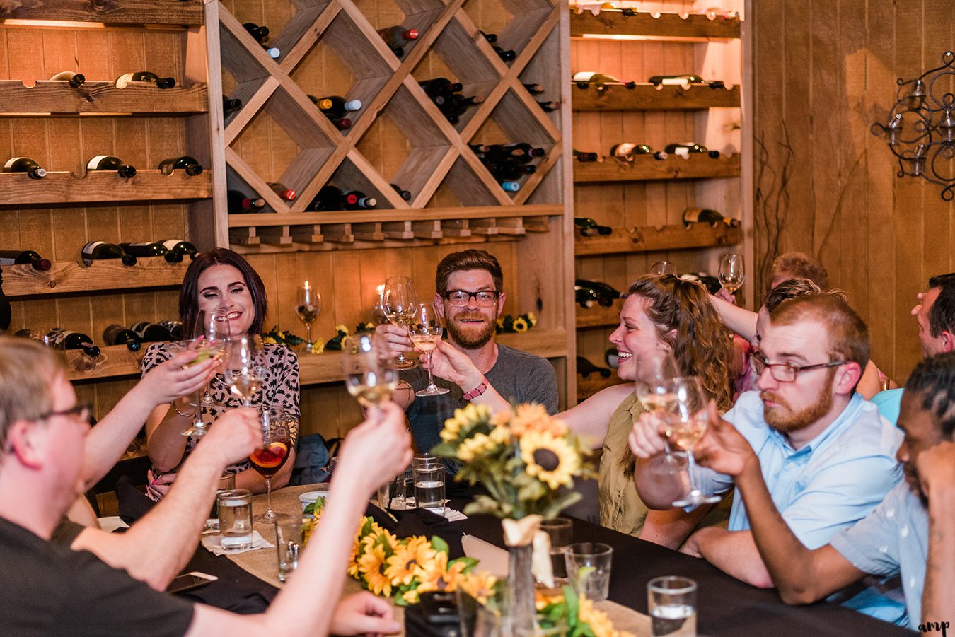 The group shares a toast at the Wine Dive