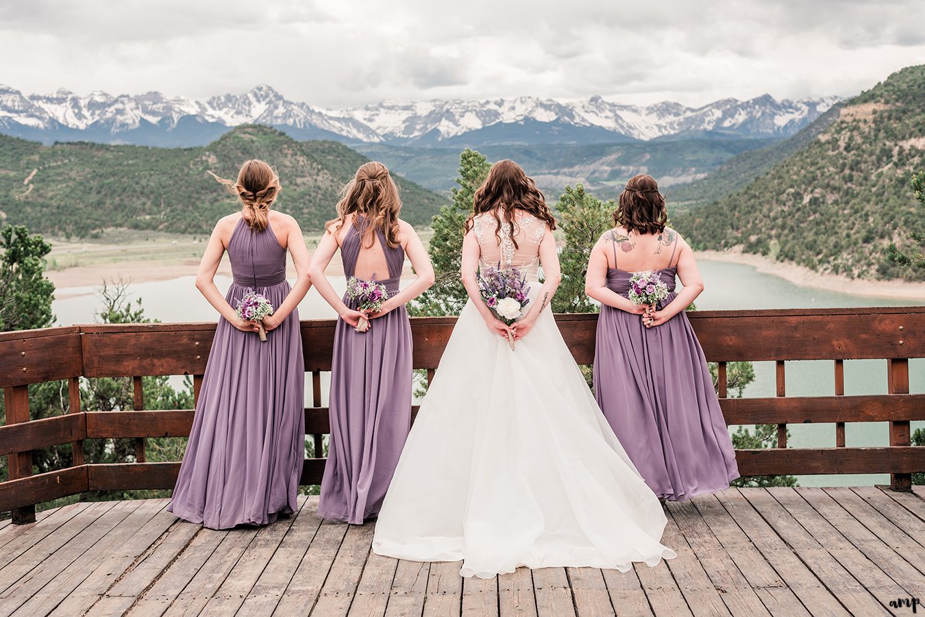 Erica and her bridesmaids hold their bouquets at the Ridgway State Park Overlook