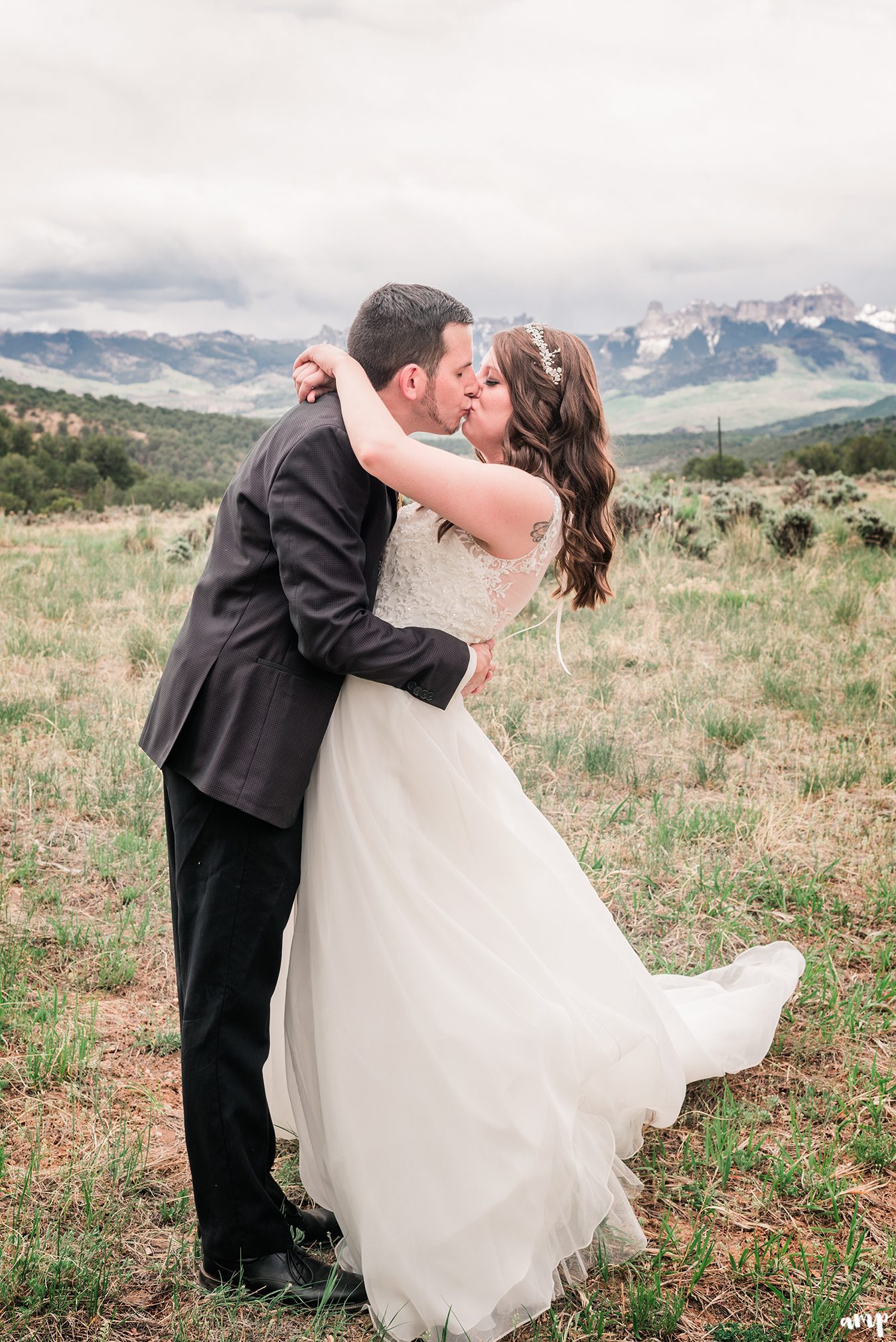 Travis dips Erica for a kiss in front of chimney rock | Ridgway Colorado