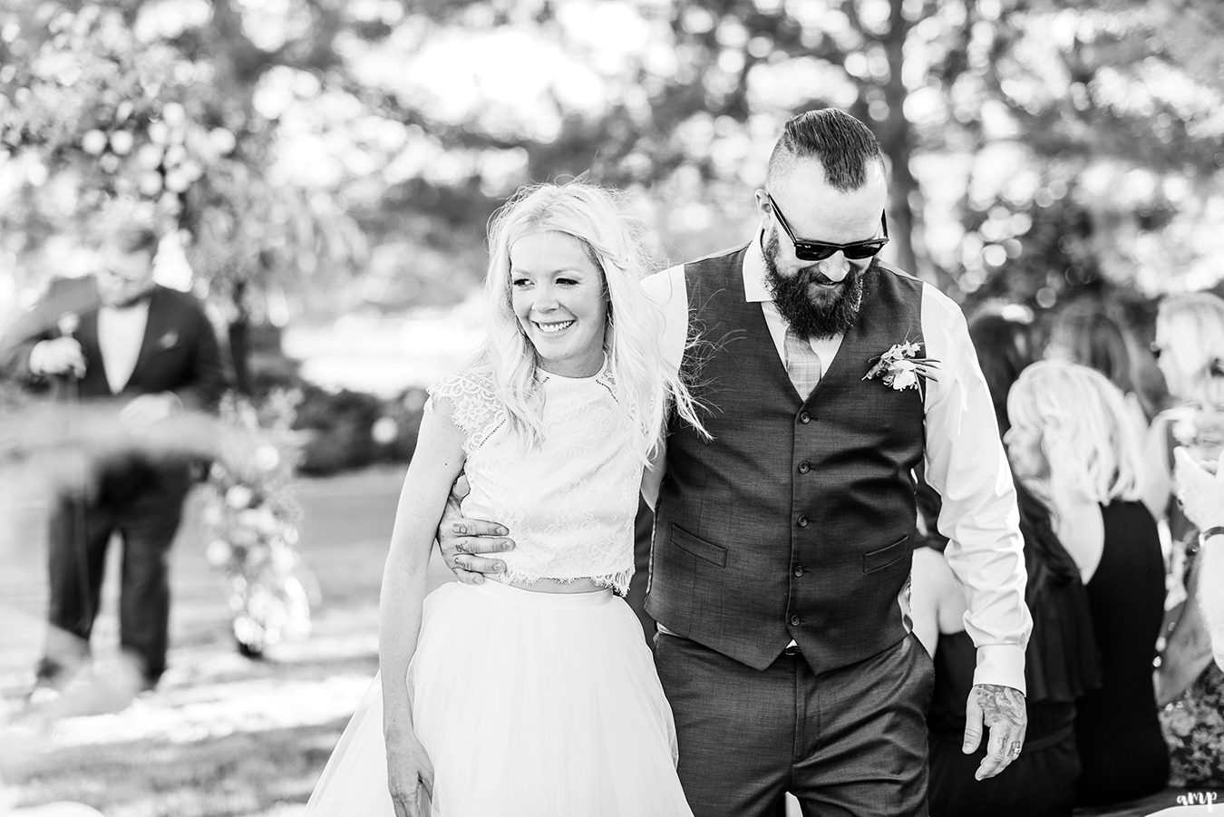 Beth and Dustin walking out of ceremony arm-in-arm | Grand Junction Backyard Wedding | amanda.matilda.photography