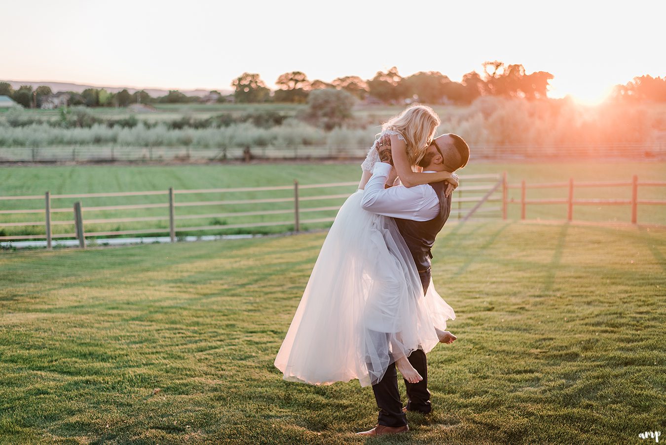 Beth leaping into Dustin's arms with sunset behind | Grand Junction Backyard Wedding | amanda.matilda.photography