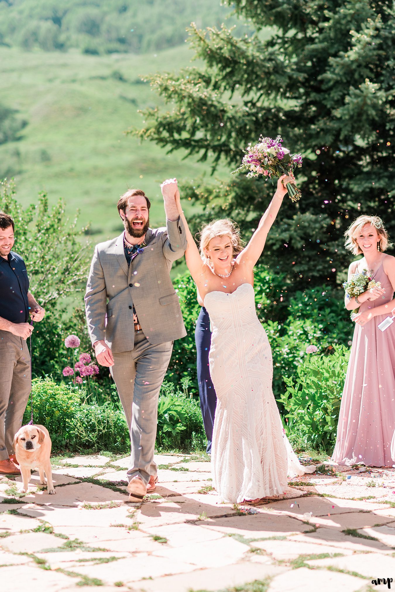 Dan and Courtney celebrate as they come back up the aisle with confetti in the air