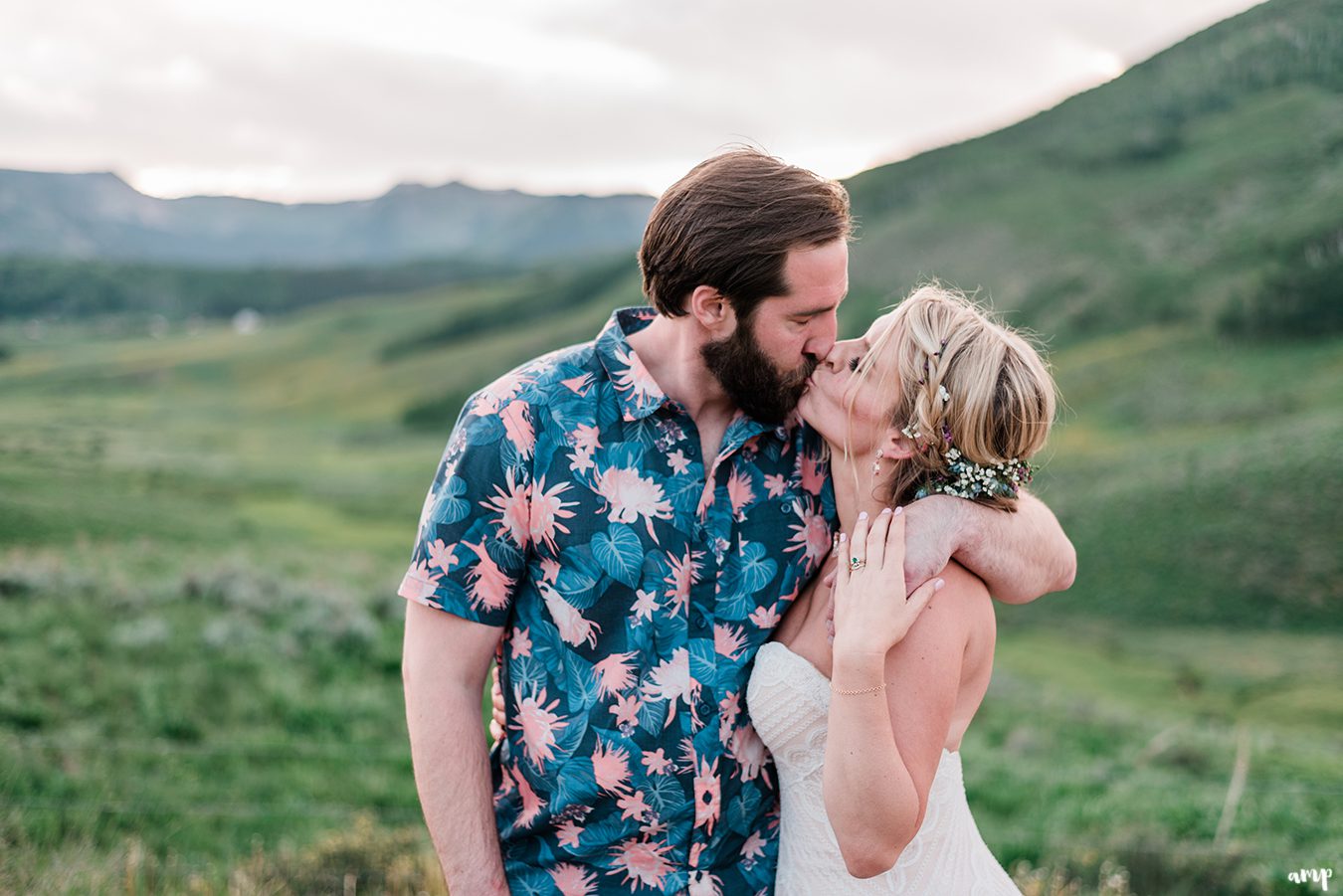 Bride and groom share a kiss at sunset at the Mountain Wedding Garden