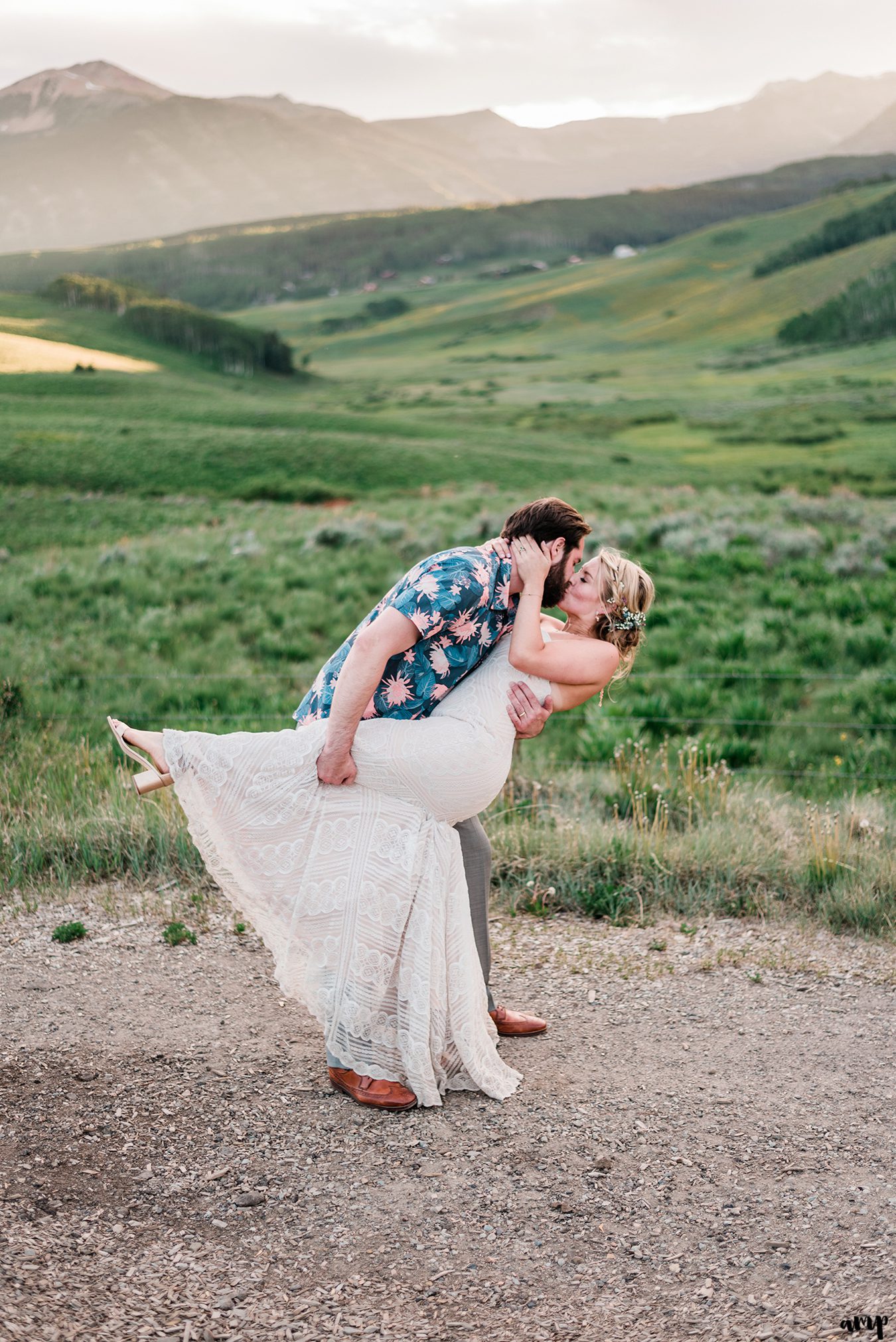 Bride and groom share a kiss at sunset at the Mountain Wedding Garden