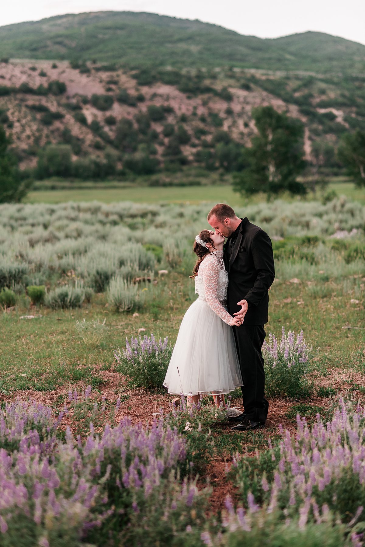 Josh & Annie in a field of purple lupine at Rolling R Ranch near Meeker