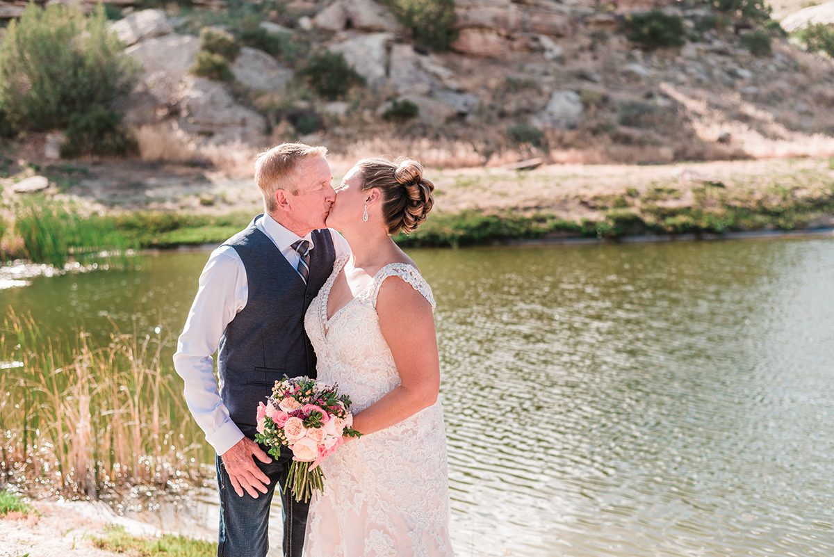 Bob & Jamie in front of a pond water hazard at Redlands Mesa Golf Course