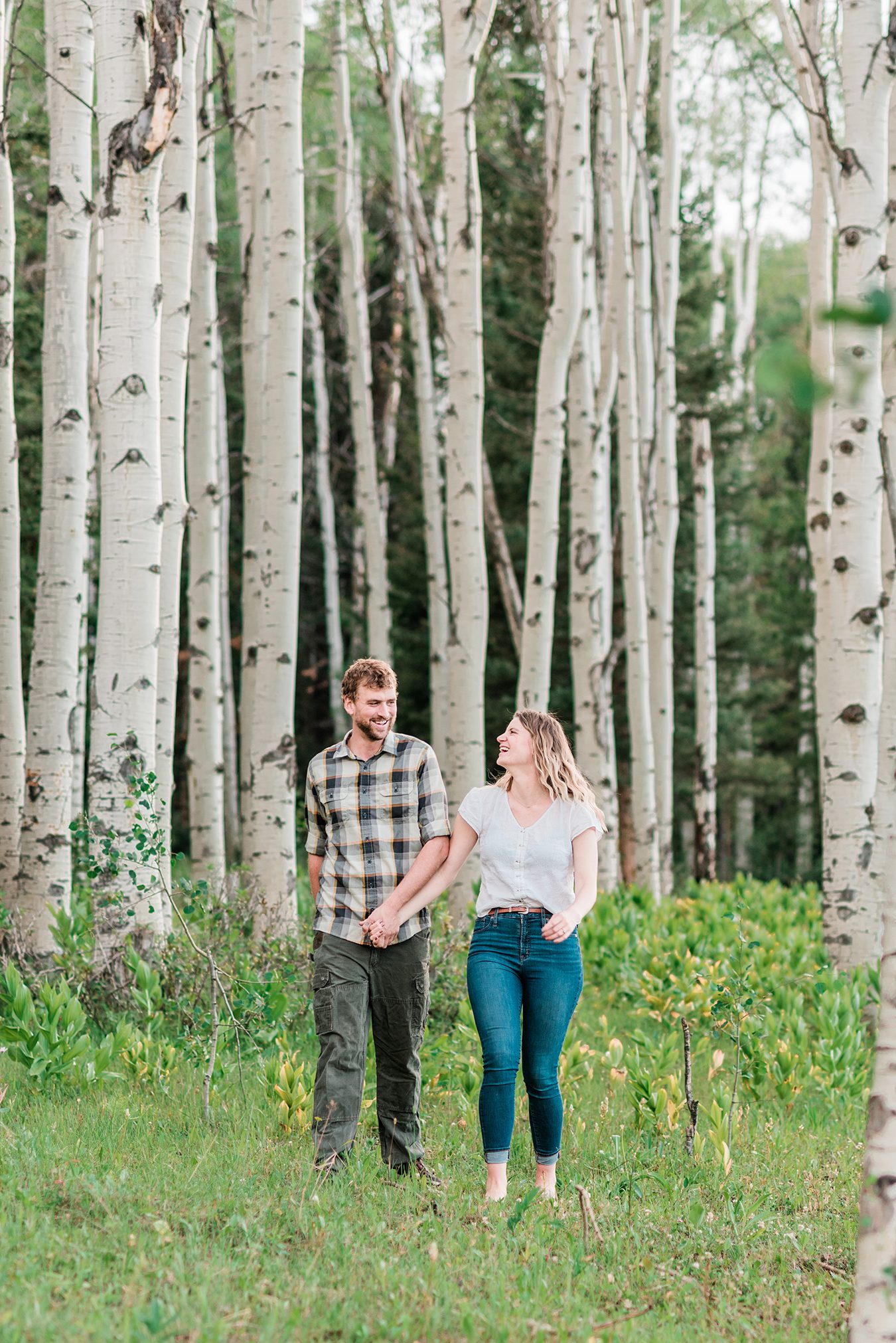 Annie & Taylorwalk through an Aspen glen for their Glenwood Springs Engagement Photos