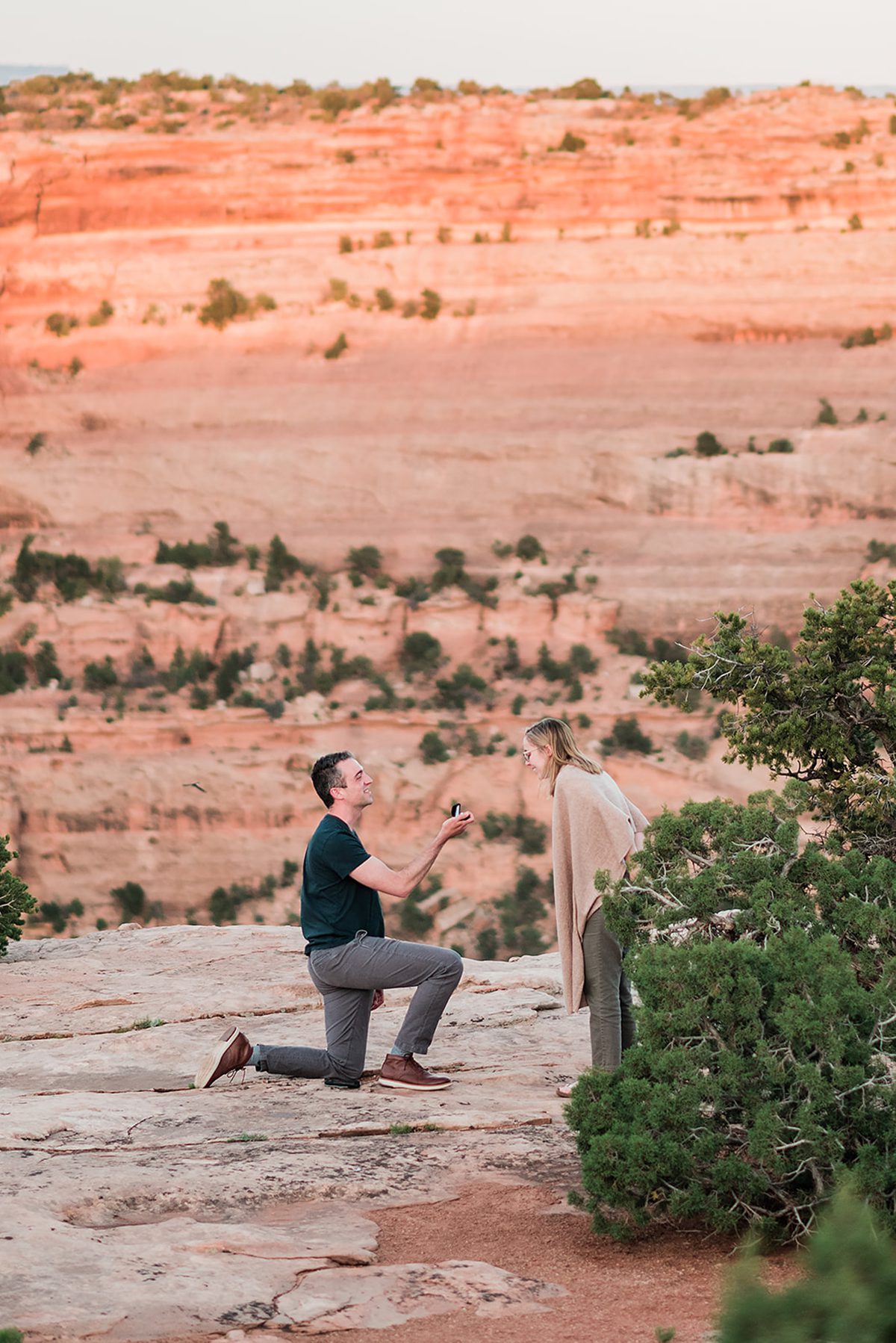 Eric down on one knee while Colette looks surprised | Surprise Proposal at Colorado National Monument