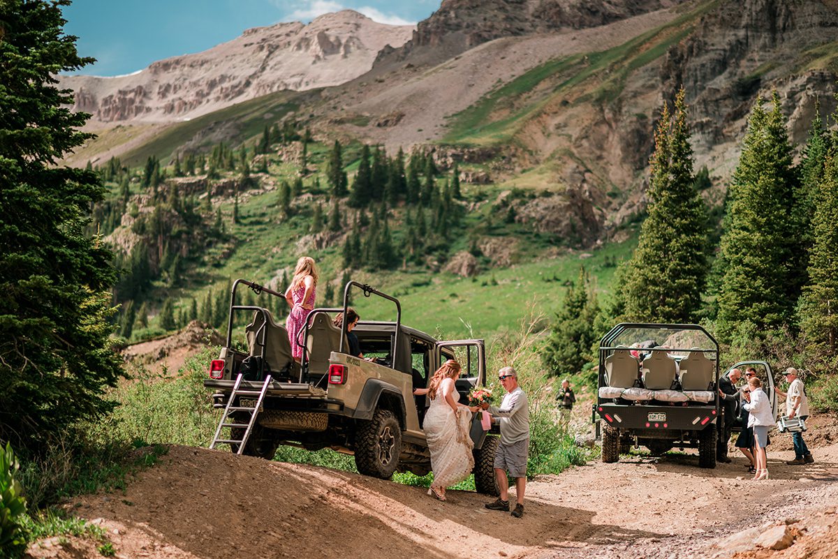 Bride climbs out of the jeep in Yankee Boy Basin