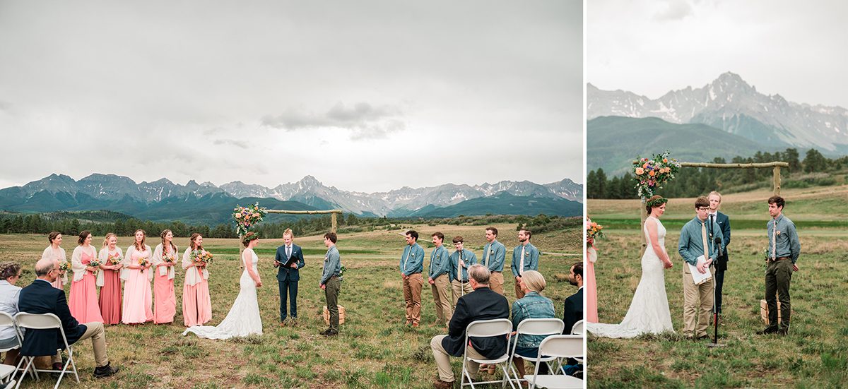 Tom and Sarah stand accompanied by their wedding party with the mountaintops along the horizon behind