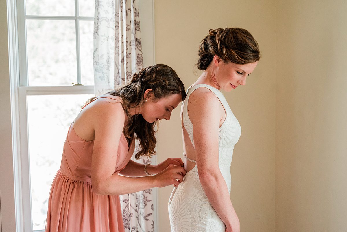 Her sister helps Sarah into her dress